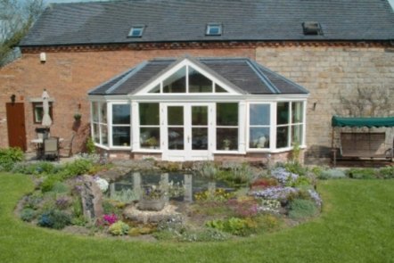 Hardwood Garden Room with Tiled Roof Hardwood Garden Room with Tiled Roof, designed and built by Abbey & Burton Glass in the Derby and Burton areas.