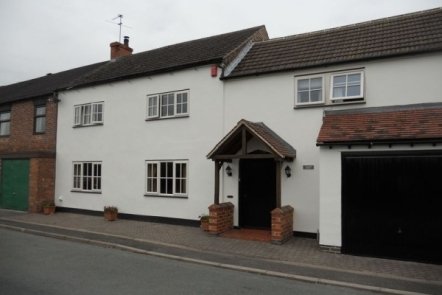 Ivory Woodgrain PVCu with Black Cill, 